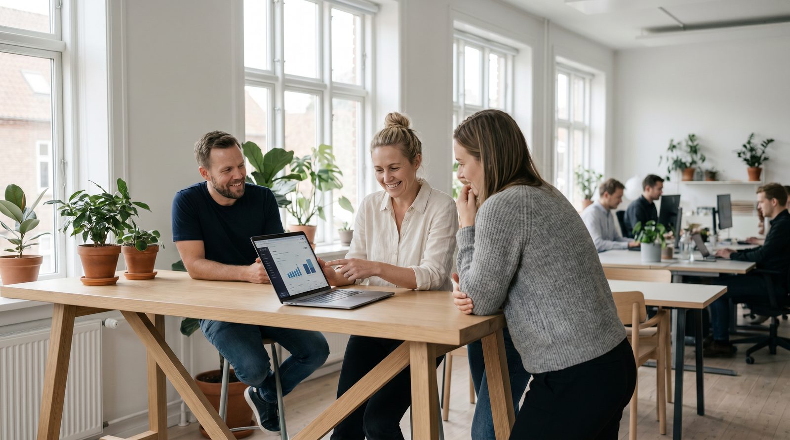 A hiring panel reviewing scorecards together around a laptop